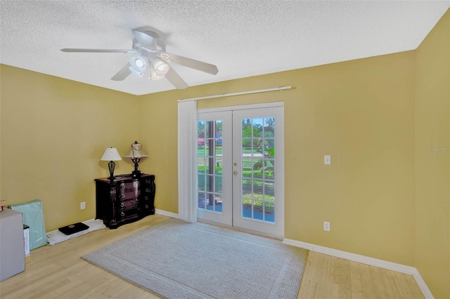 7655 Persian Ct, Orlando, FL 32819 - interior space featuring wood finished floors, a textured ceiling, ceiling fan, and french doors