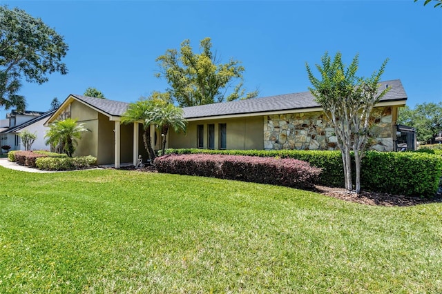 7655 Persian Ct, Orlando, FL 32819 - single story home featuring stone siding, a front lawn, and stucco siding
