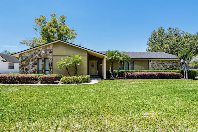 7655 Persian Ct, Orlando, FL 32819 - view of front facade featuring stucco siding, stone siding, and a front yard
