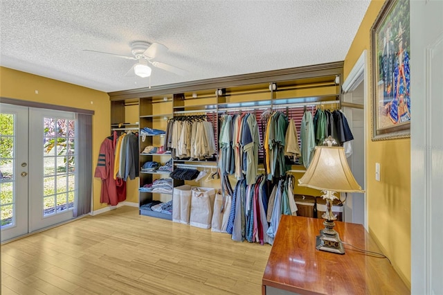 7655 Persian Ct, Orlando, FL 32819 - walk in closet with wood finished floors, ceiling fan, and french doors