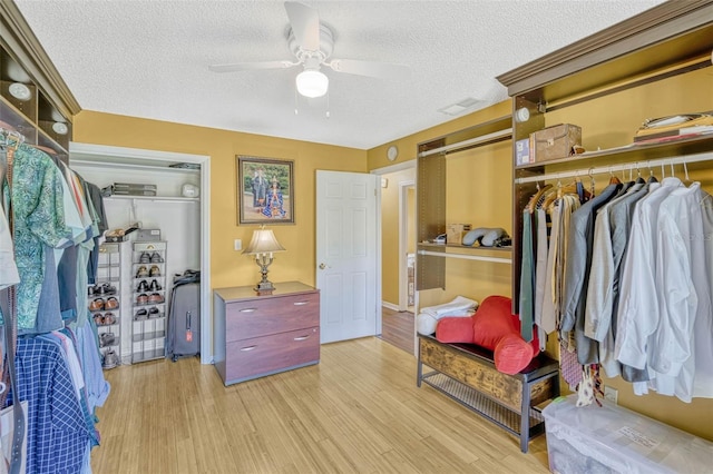 7655 Persian Ct, Orlando, FL 32819 - spacious closet with ceiling fan, light wood-style floors, and visible vents