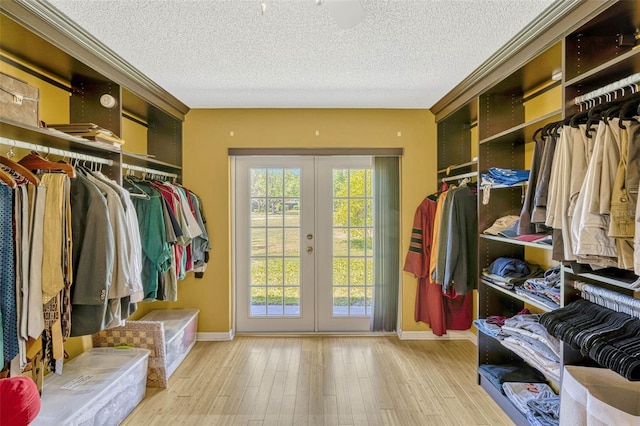 7655 Persian Ct, Orlando, FL 32819 - walk in closet featuring french doors and wood finished floors