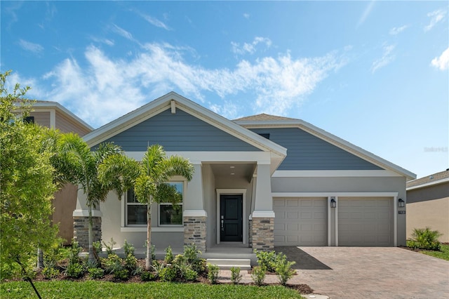 1908 Blissful Dr, Kissimmee, FL 34744 - craftsman inspired home with an attached garage, stucco siding, stone siding, and decorative driveway