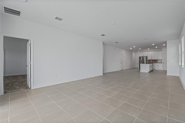 1908 Blissful Dr, Kissimmee, FL 34744 - unfurnished living room featuring light tile patterned floors, visible vents, and recessed lighting