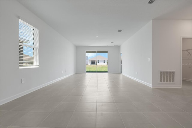 1908 Blissful Dr, Kissimmee, FL 34744 - tiled spare room featuring visible vents and baseboards