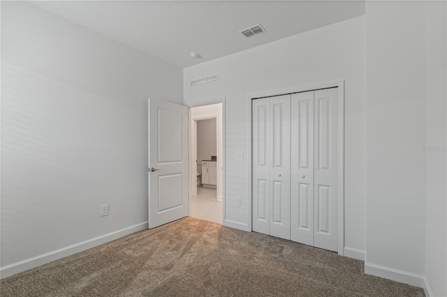 1908 Blissful Dr, Kissimmee, FL 34744 - unfurnished bedroom featuring a closet, visible vents, baseboards, and carpet floors