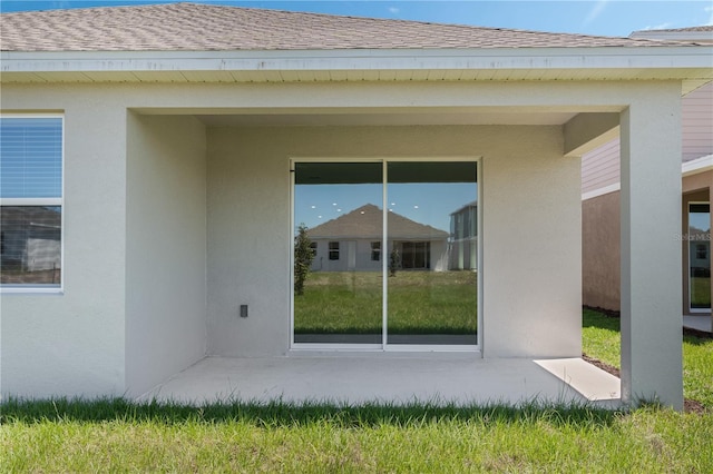 1908 Blissful Dr, Kissimmee, FL 34744 - back of house with a shingled roof and stucco siding