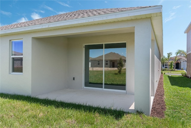 1908 Blissful Dr, Kissimmee, FL 34744 - back of house featuring roof with shingles and stucco siding