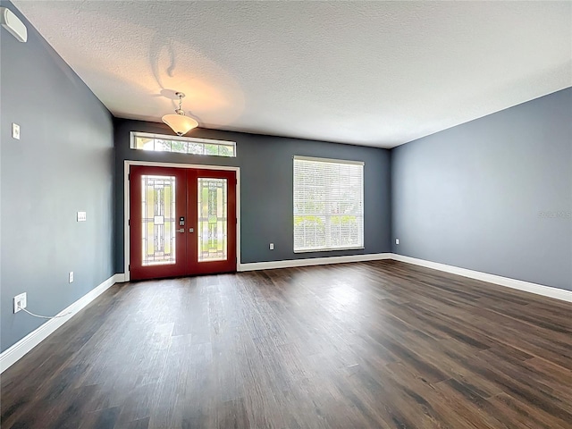 foyer with dark wood finished floors, a wealth of natural light, and baseboards