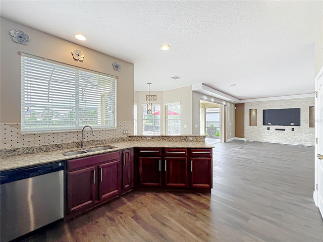 kitchen with dishwasher, wood finished floors, reddish brown cabinets, a sink, and open floor plan