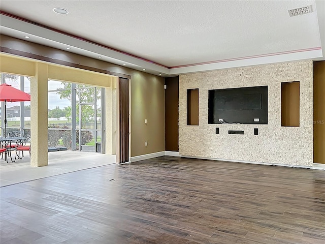 unfurnished living room featuring recessed lighting, wood finished floors, visible vents, baseboards, and a textured ceiling