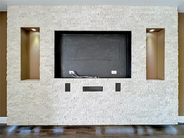 interior details with baseboards and wood finished floors