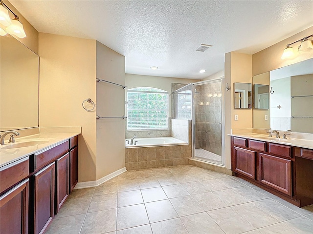 full bath featuring a shower stall, tile patterned floors, a sink, a bath, and visible vents