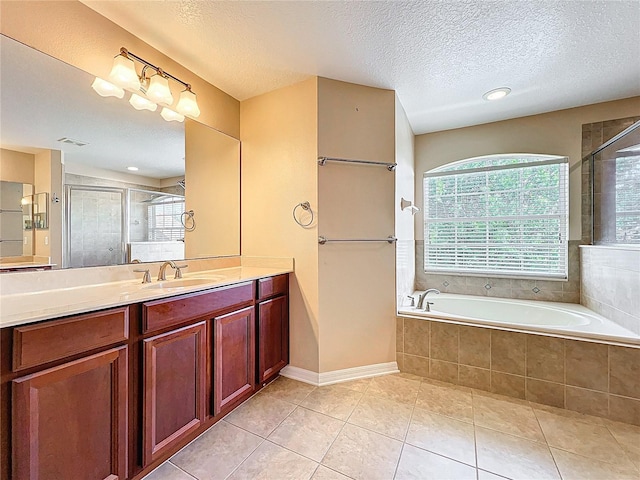 full bathroom featuring plenty of natural light, a garden tub, tile patterned floors, and a stall shower