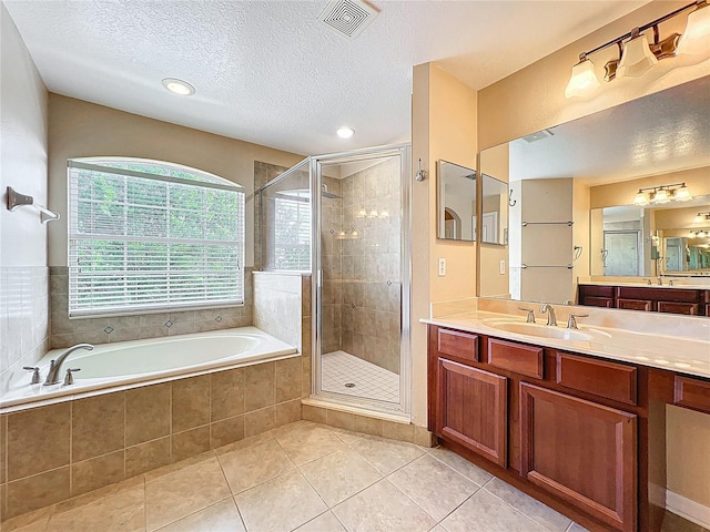 full bathroom featuring a bath, visible vents, tile patterned floors, and a stall shower