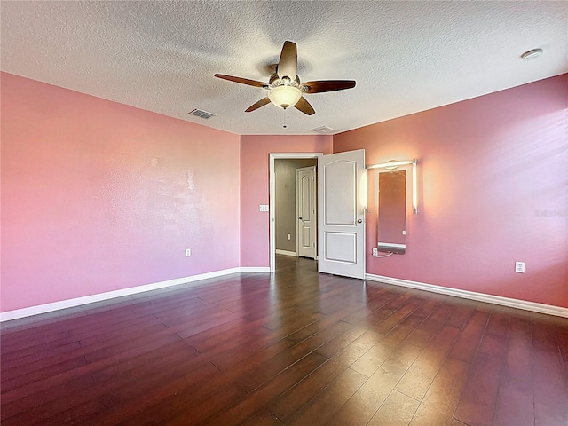 unfurnished bedroom featuring dark wood-type flooring, visible vents, and baseboards