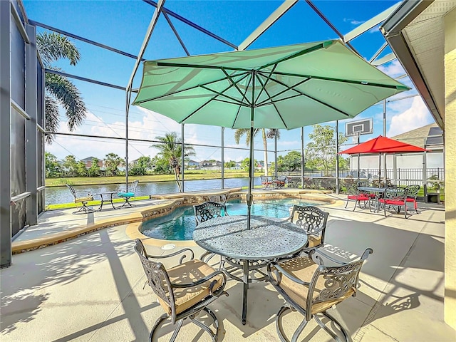 outdoor pool featuring a lanai, a water view, and a patio area