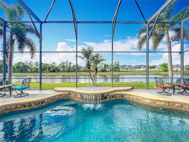 pool featuring a lanai, a water view, and a patio area