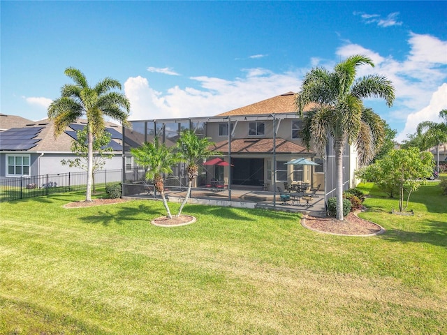 back of property with a lawn, fence, a patio area, and stucco siding