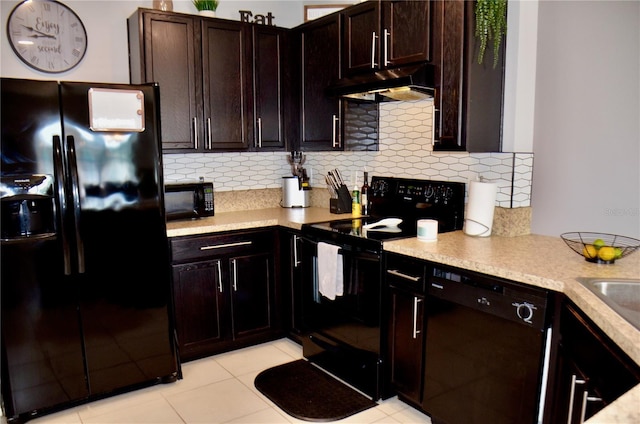 3416 Seneca Club Loop Unit 56, Orlando, FL 32808 - kitchen featuring dark brown cabinets, under cabinet range hood, black appliances, and tasteful backsplash