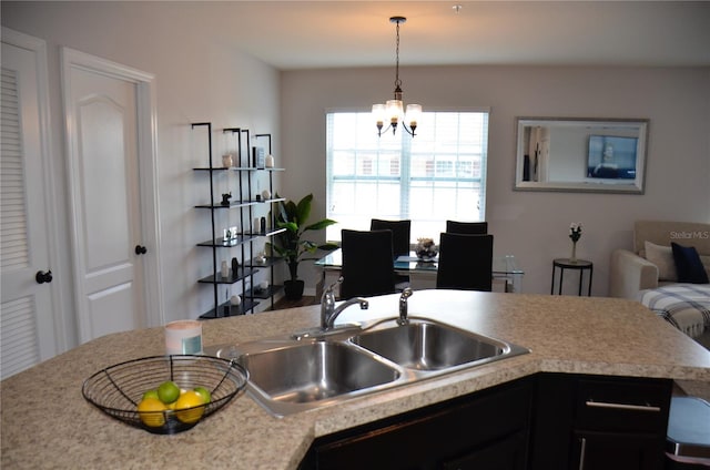 3416 Seneca Club Loop Unit 56, Orlando, FL 32808 - kitchen featuring an inviting chandelier, light countertops, pendant lighting, and a sink