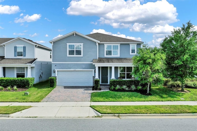 3259 Buoy Cir, Winter Garden, FL 34787 - view of front of house featuring a front yard, an attached garage, driveway, and stucco siding