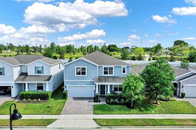 3259 Buoy Cir, Winter Garden, FL 34787 - view of front of property with a front yard, an attached garage, stucco siding, a residential view, and decorative driveway