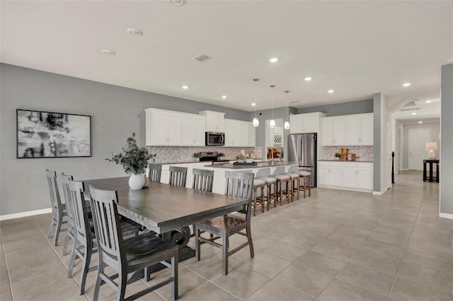 3259 Buoy Cir, Winter Garden, FL 34787 - dining area featuring light tile patterned floors, baseboards, visible vents, and recessed lighting