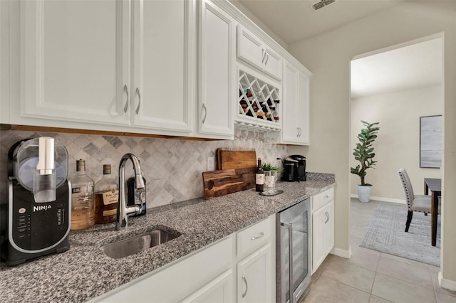3259 Buoy Cir, Winter Garden, FL 34787 - bar with tasteful backsplash, light tile patterned floors, indoor bar, wine cooler, and a sink