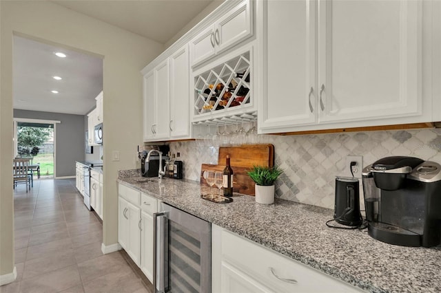 3259 Buoy Cir, Winter Garden, FL 34787 - bar with light tile patterned floors, recessed lighting, stainless steel microwave, beverage cooler, and backsplash