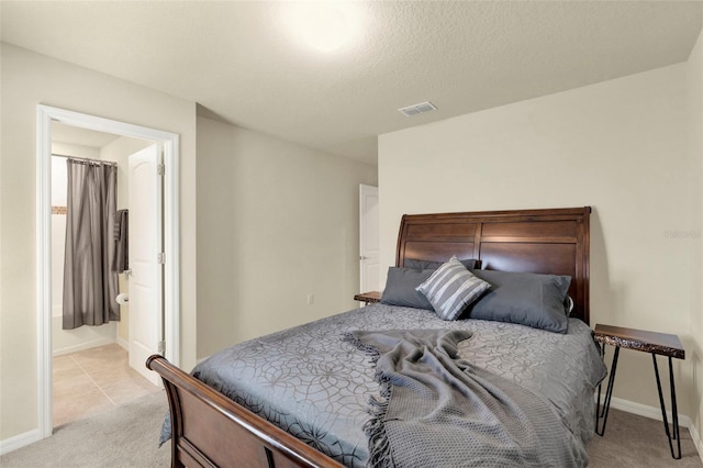 3259 Buoy Cir, Winter Garden, FL 34787 - bedroom featuring visible vents, light colored carpet, baseboards, and connected bathroom