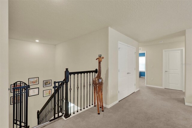 3259 Buoy Cir, Winter Garden, FL 34787 - hall with baseboards, recessed lighting, carpet flooring, an upstairs landing, and a textured ceiling