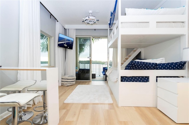 8800 Bay Pines Blvd Unit 306, Saint Petersburg, FL 33709 - bedroom featuring multiple windows, light wood-style floors, and access to exterior