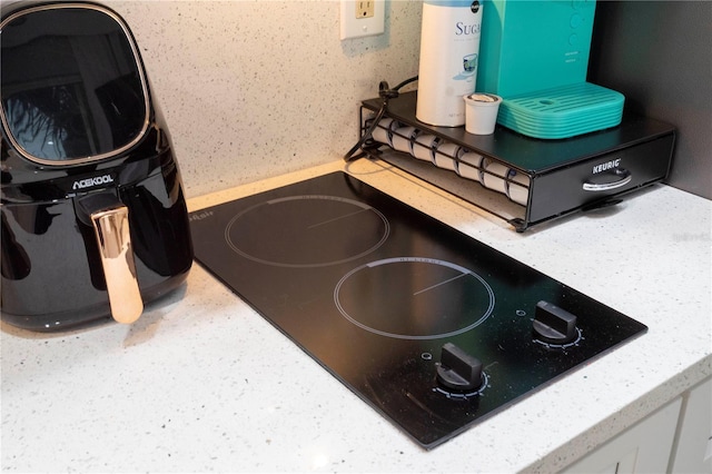 8800 Bay Pines Blvd Unit 306, Saint Petersburg, FL 33709 - room details with white cabinetry and black electric stovetop