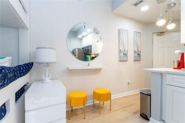 8800 Bay Pines Blvd Unit 306, Saint Petersburg, FL 33709 - bathroom with baseboards, vanity, wood finished floors, and visible vents