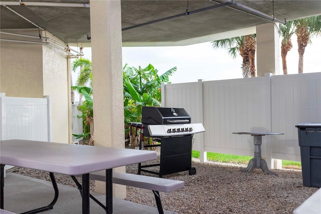 8800 Bay Pines Blvd Unit 306, Saint Petersburg, FL 33709 - view of patio / terrace featuring outdoor dining area, area for grilling, and fence