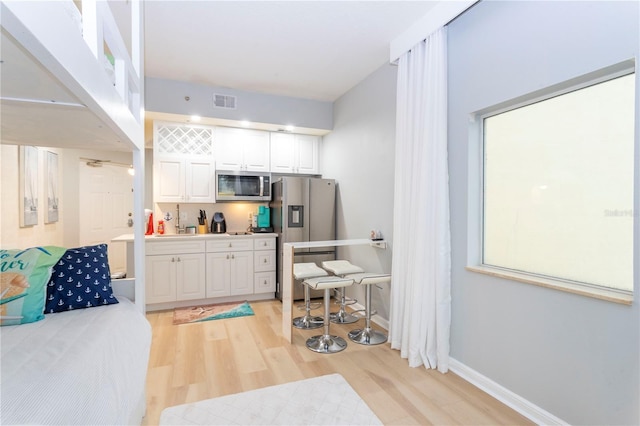 8800 Bay Pines Blvd Unit 306, Saint Petersburg, FL 33709 - interior space featuring light wood-type flooring, visible vents, baseboards, and stainless steel appliances