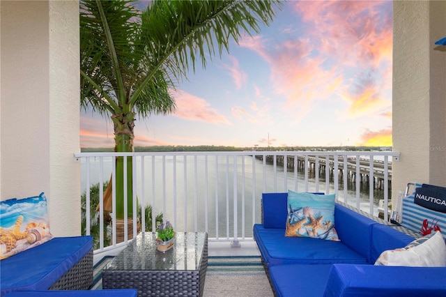 8800 Bay Pines Blvd Unit 306, Saint Petersburg, FL 33709 - balcony at dusk with outdoor lounge area and a water view