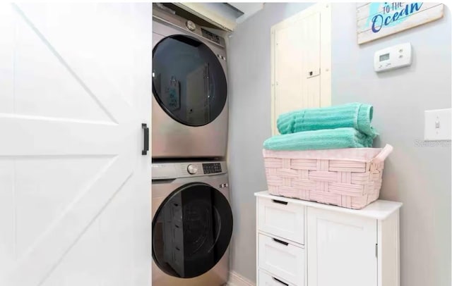 8800 Bay Pines Blvd Unit 306, Saint Petersburg, FL 33709 - clothes washing area featuring stacked washer / dryer and laundry area