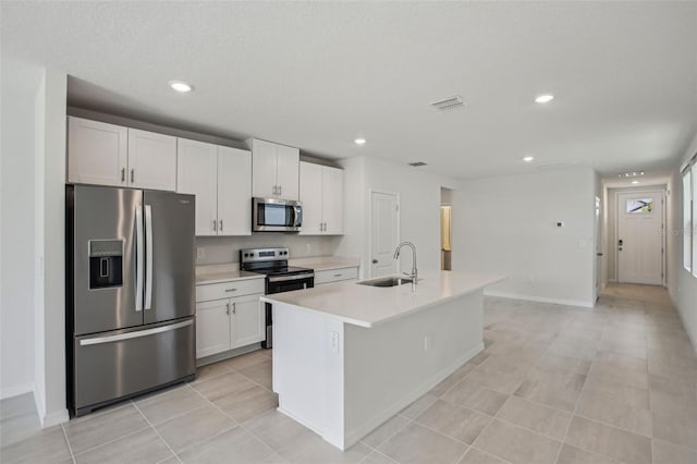 1839 Brekey Way, Zephyrhills, FL 33541 - kitchen with stainless steel appliances, a sink, white cabinetry, light countertops, and recessed lighting
