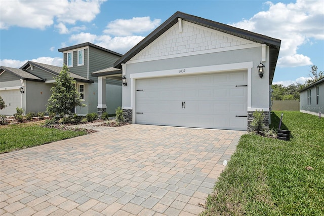 1839 Brekey Way, Zephyrhills, FL 33541 - view of front facade with stone siding, decorative driveway, a front lawn, and stucco siding