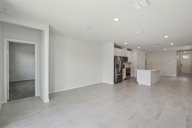 1839 Brekey Way, Zephyrhills, FL 33541 - unfurnished living room featuring a sink, light tile patterned floors, recessed lighting, and baseboards