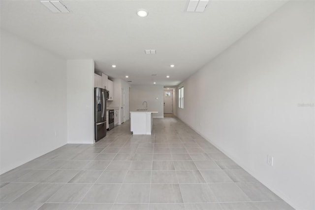 1839 Brekey Way, Zephyrhills, FL 33541 - unfurnished living room featuring a sink, recessed lighting, and light tile patterned floors