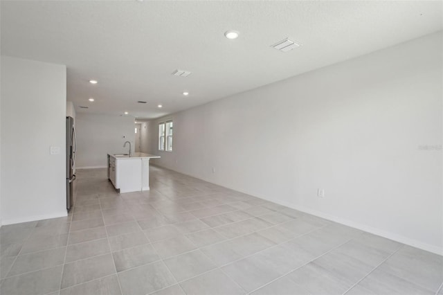 1839 Brekey Way, Zephyrhills, FL 33541 - unfurnished living room with a sink, recessed lighting, and baseboards
