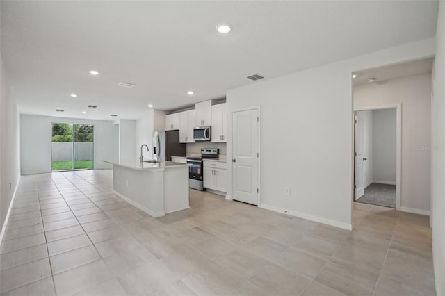 1839 Brekey Way, Zephyrhills, FL 33541 - kitchen with appliances with stainless steel finishes, a sink, white cabinetry, an island with sink, and open floor plan