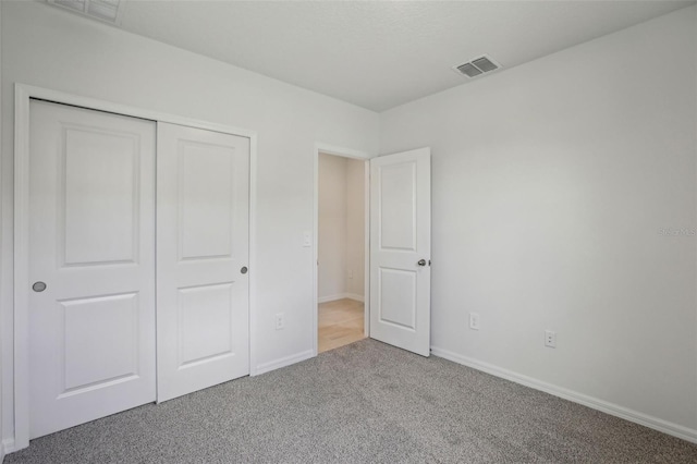 1839 Brekey Way, Zephyrhills, FL 33541 - unfurnished bedroom featuring carpet, baseboards, and a closet