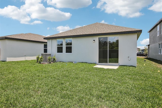 1839 Brekey Way, Zephyrhills, FL 33541 - rear view of house with stucco siding, a yard, central AC unit, and roof with shingles