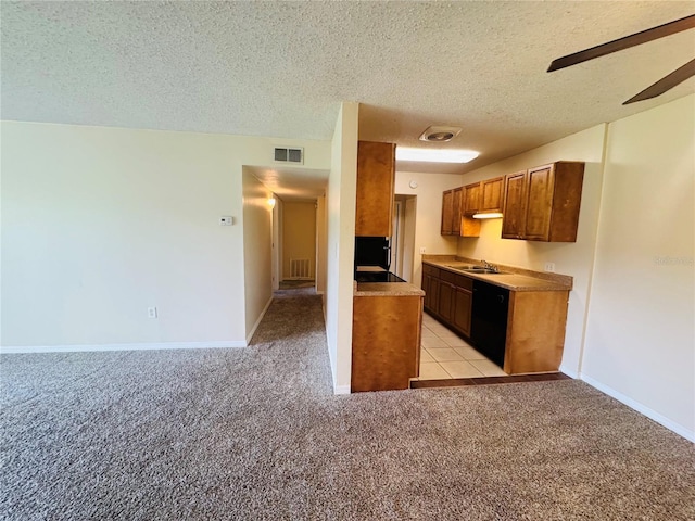 1695 Lee Rd Unit E214, Winter Park, FL 32789 - kitchen featuring black dishwasher, light carpet, a sink, a textured ceiling, and a ceiling fan