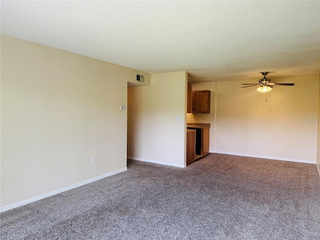 1695 Lee Rd Unit E214, Winter Park, FL 32789 - unfurnished living room with carpet, a ceiling fan, a textured ceiling, and baseboards