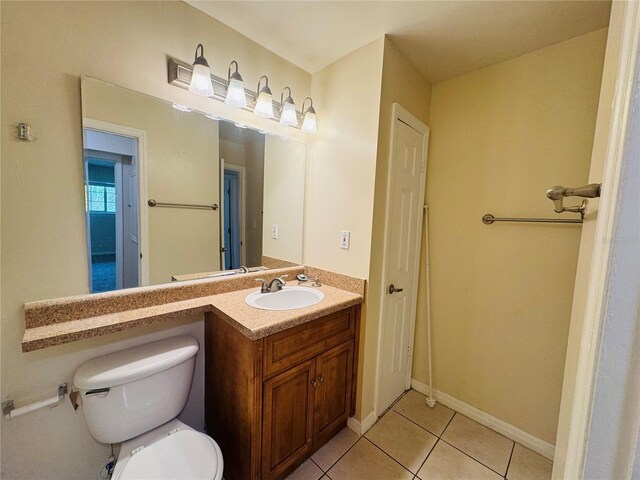 1695 Lee Rd Unit E214, Winter Park, FL 32789 - bathroom featuring tile patterned flooring, toilet, vanity, and baseboards